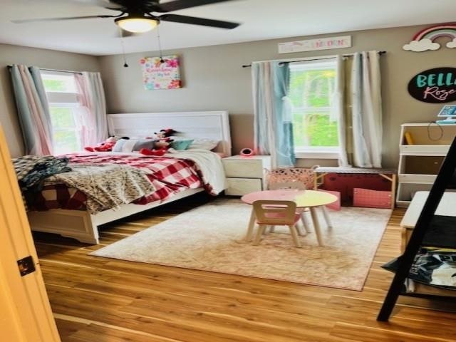 bedroom with a ceiling fan and light wood finished floors