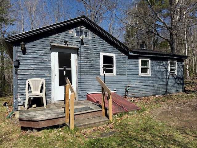 back of property featuring a wooden deck and a chimney