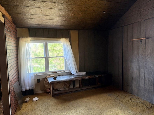 bedroom with wood walls, vaulted ceiling, and wooden ceiling