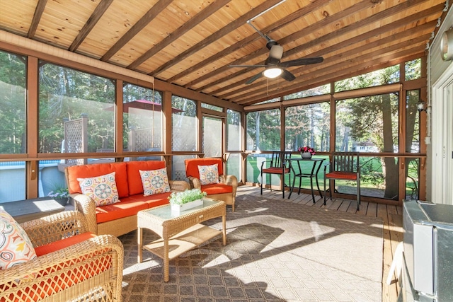 sunroom / solarium featuring ceiling fan, outdoor lounge area, and beam ceiling