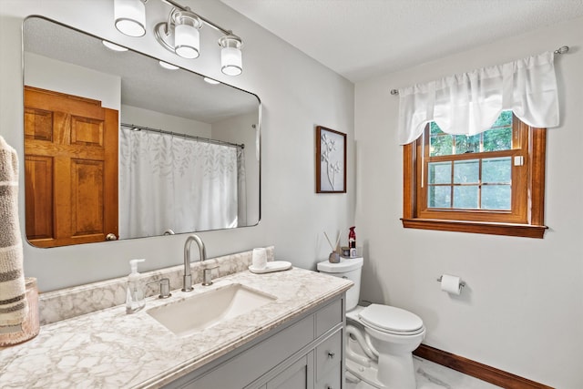 full bathroom with toilet, baseboards, and vanity