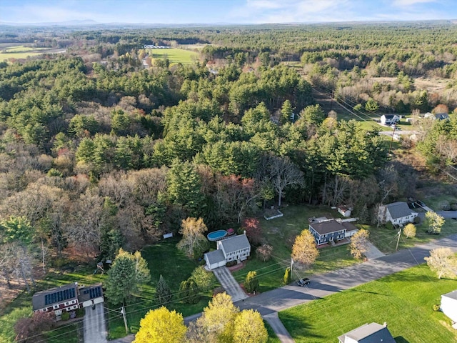 birds eye view of property featuring a forest view