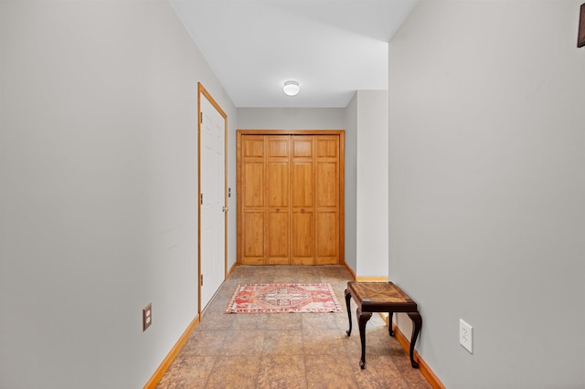 hallway featuring baseboards