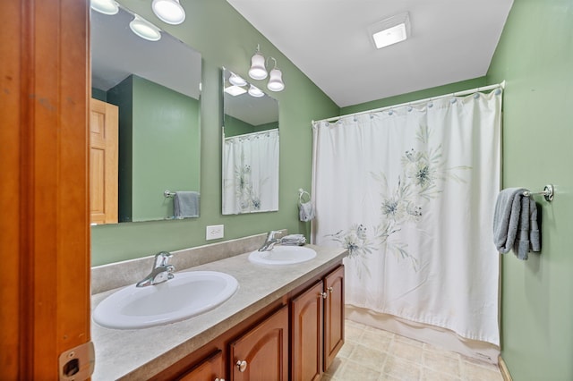 bathroom with a sink, shower / bathtub combination with curtain, and double vanity