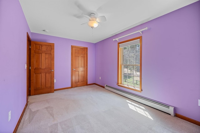 unfurnished bedroom featuring light colored carpet, a baseboard radiator, and baseboards