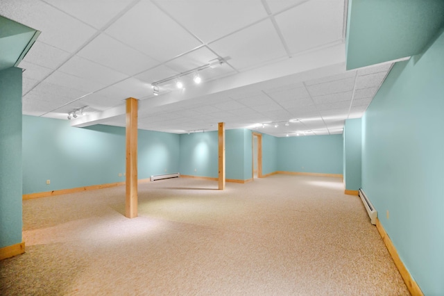 finished below grade area with carpet, baseboards, and baseboard heating