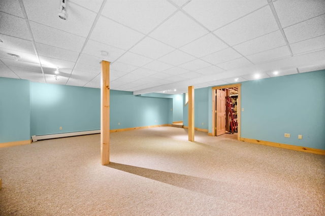 finished basement featuring carpet floors, a baseboard heating unit, and a drop ceiling