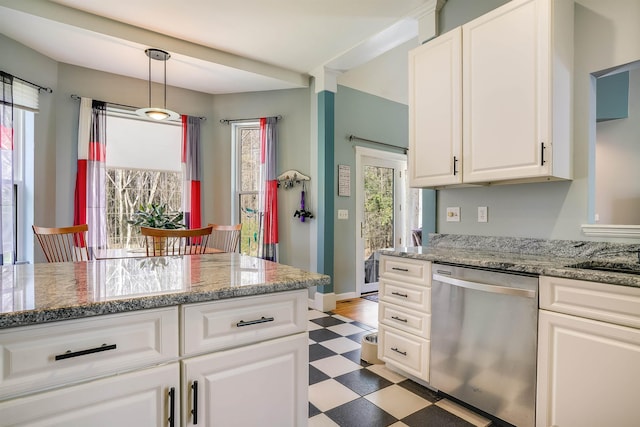 kitchen with stainless steel dishwasher, light floors, a wealth of natural light, and white cabinetry