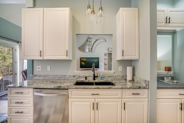 kitchen with a sink, white cabinets, stainless steel dishwasher, and light stone countertops