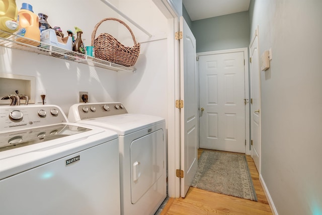 laundry room featuring washer and dryer, laundry area, and light wood finished floors