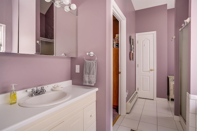 bathroom with vanity, baseboards, tile patterned flooring, and a baseboard radiator