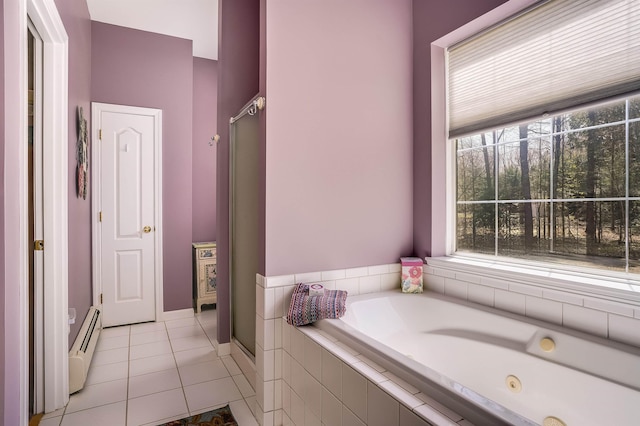 full bath with a stall shower, baseboard heating, and a healthy amount of sunlight