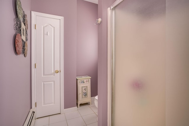bathroom with tile patterned floors, baseboard heating, toilet, and a shower stall