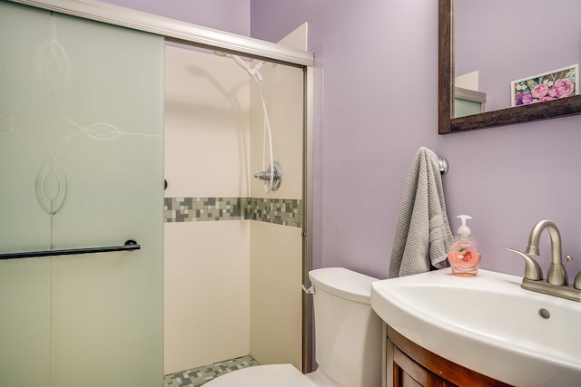full bath featuring vanity, toilet, and a shower stall