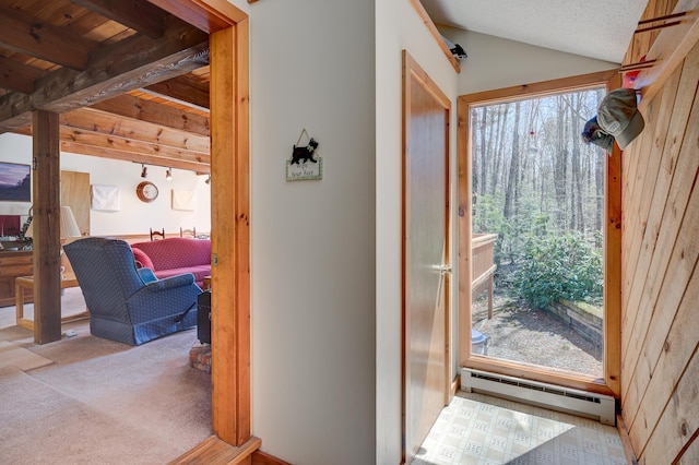 interior space with vaulted ceiling with beams, a baseboard radiator, and carpet flooring