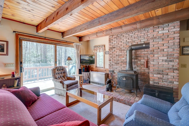 living area with carpet floors, wooden ceiling, beam ceiling, and a wood stove