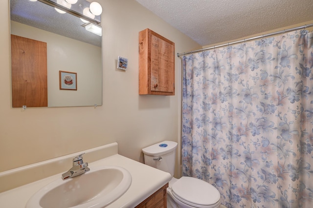 bathroom with toilet, a textured ceiling, a shower with curtain, and vanity