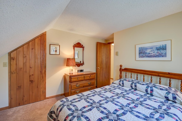 carpeted bedroom featuring baseboards, a textured ceiling, and lofted ceiling