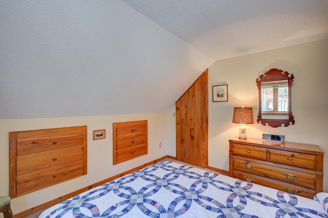 bedroom featuring baseboards, carpet, a textured ceiling, and vaulted ceiling