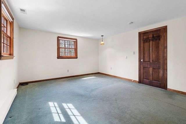 carpeted empty room featuring visible vents and baseboards