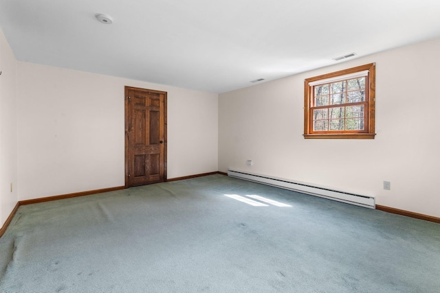 carpeted empty room featuring baseboards, a baseboard heating unit, and visible vents