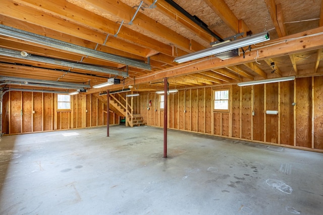 below grade area featuring plenty of natural light, stairs, and a garage