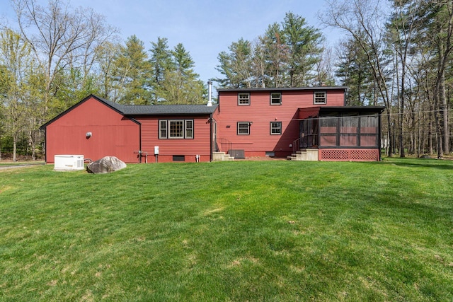 back of house with a yard, a sunroom, and cooling unit