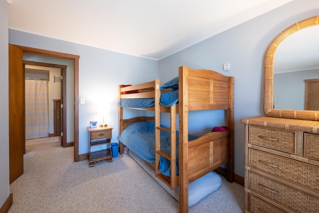 bedroom featuring crown molding, baseboards, and light carpet