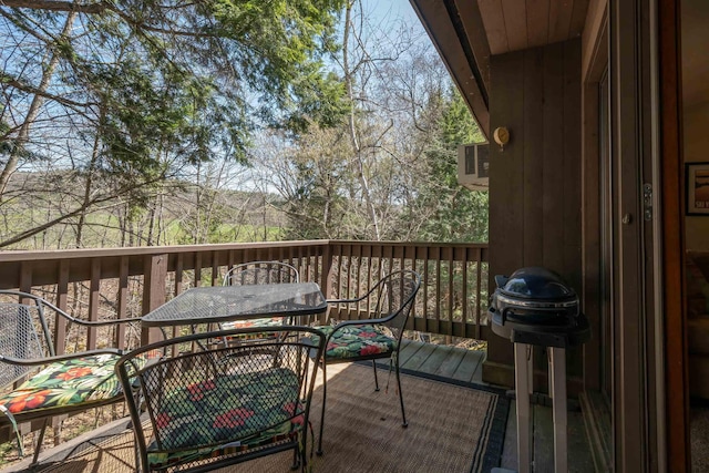 view of wooden balcony featuring outdoor dining area and a wooden deck