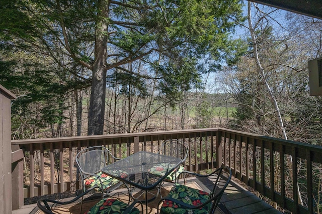 wooden terrace with outdoor dining space