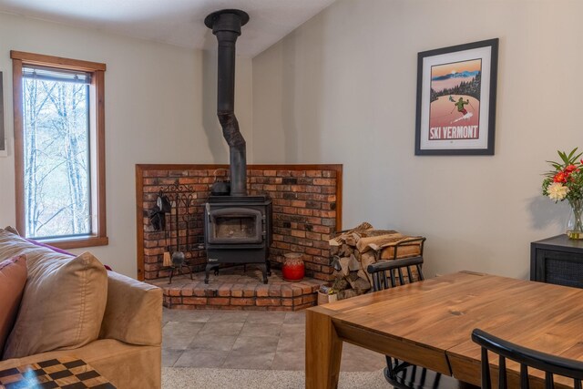 living room featuring plenty of natural light and a wood stove