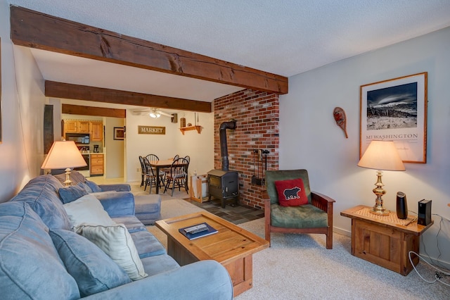 4D Seasons At Attitash Rd Unit D, Bartlett, NH 03812 - living room with a wood stove, a ceiling fan, light colored carpet, beam ceiling, and baseboards