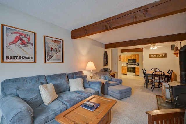 4D Seasons At Attitash Rd Unit D, Bartlett, NH 03812 - living room featuring a wood stove, light colored carpet, a ceiling fan, beamed ceiling, and a textured ceiling