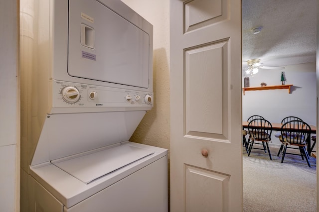 4D Seasons At Attitash Rd Unit D, Bartlett, NH 03812 - laundry area featuring stacked washer / dryer, light carpet, a ceiling fan, and a textured ceiling