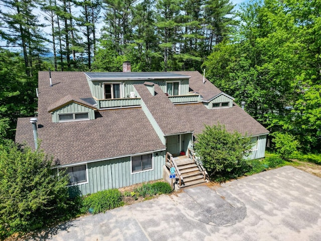 4D Seasons At Attitash Rd Unit D, Bartlett, NH 03812 - view of front of property featuring roof with shingles, board and batten siding, a chimney, a balcony, and view of scattered trees