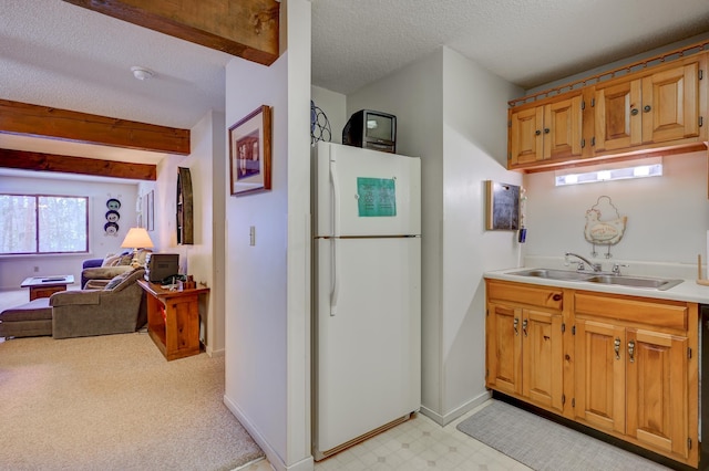 4D Seasons At Attitash Rd Unit D, Bartlett, NH 03812 - kitchen with freestanding refrigerator, a textured ceiling, a sink, light countertops, and open floor plan
