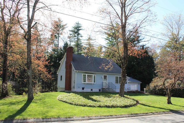view of front of house with a chimney, roof with shingles, and a front lawn
