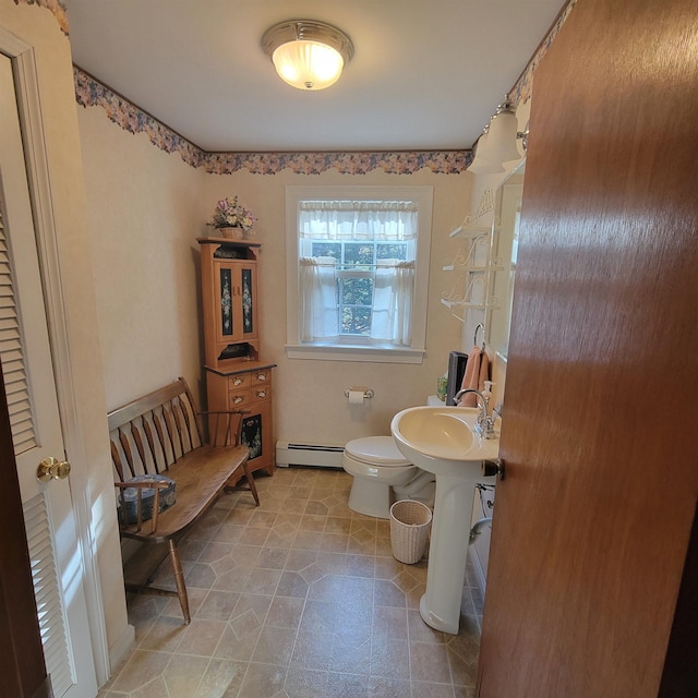 bathroom with toilet and a baseboard heating unit
