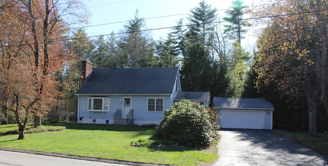 new england style home with a garage, a chimney, a front lawn, and aphalt driveway