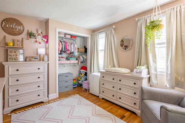 bedroom with light wood-type flooring and a closet
