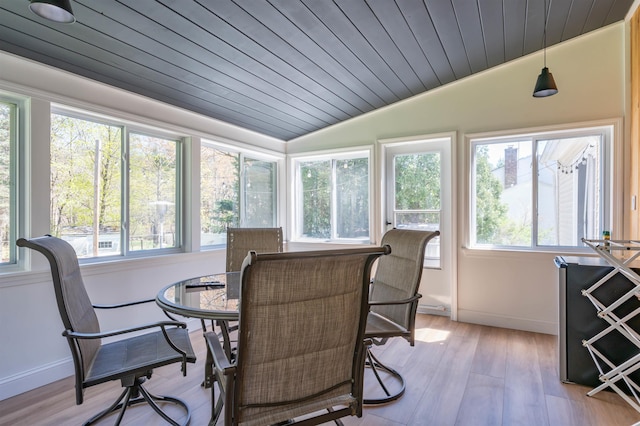 sunroom / solarium with plenty of natural light, wood ceiling, lofted ceiling, and wood finished floors