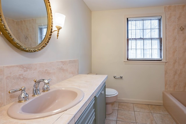 full bath with tile patterned flooring, vanity, toilet, a washtub, and walk in shower