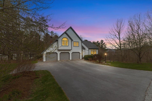view of front of property with an attached garage and aphalt driveway