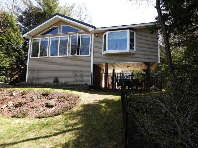 rear view of house featuring a lawn