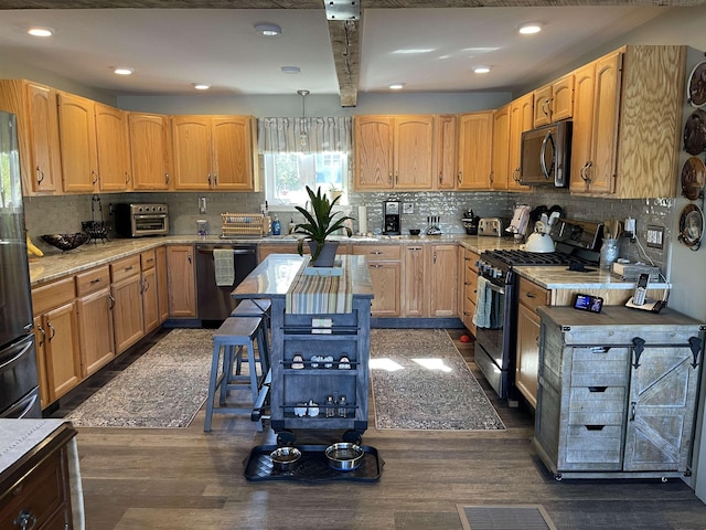 kitchen with light countertops, appliances with stainless steel finishes, decorative backsplash, and dark wood-style floors