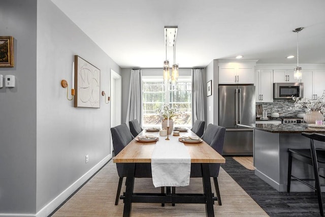 dining space with baseboards, recessed lighting, dark wood-style floors, and a chandelier