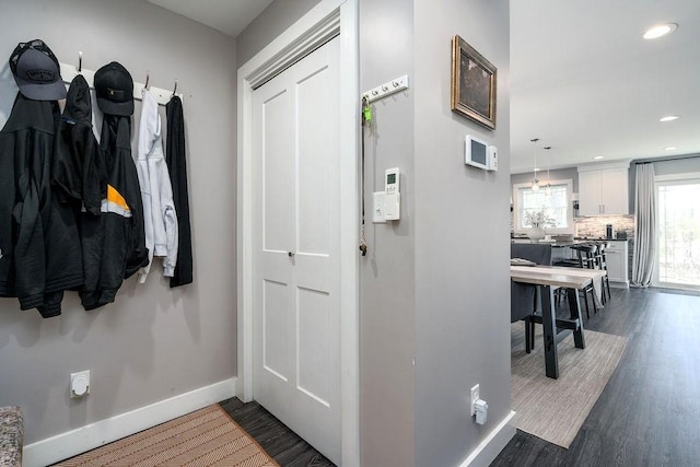 interior space featuring recessed lighting, baseboards, and dark wood-style flooring