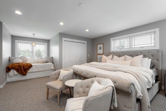 bedroom with carpet floors, multiple windows, and a closet