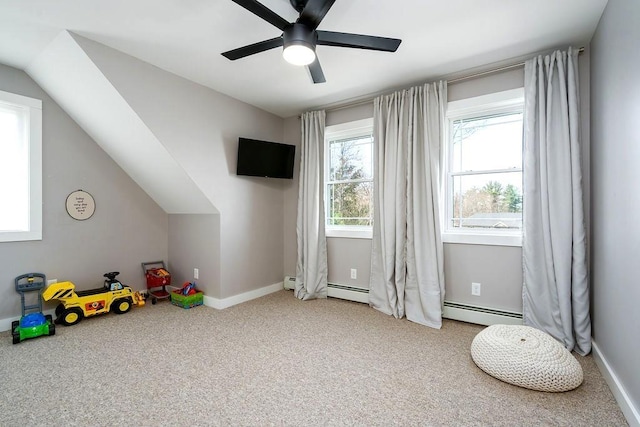 rec room featuring a ceiling fan, vaulted ceiling, carpet floors, baseboards, and a baseboard heating unit