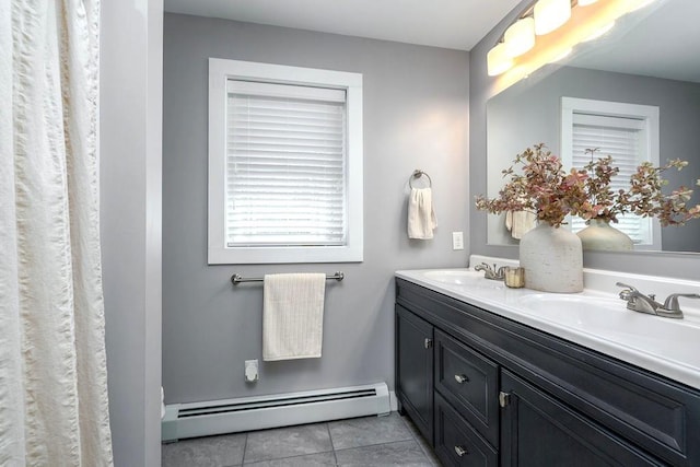 full bath featuring double vanity, a sink, tile patterned flooring, and a baseboard radiator
